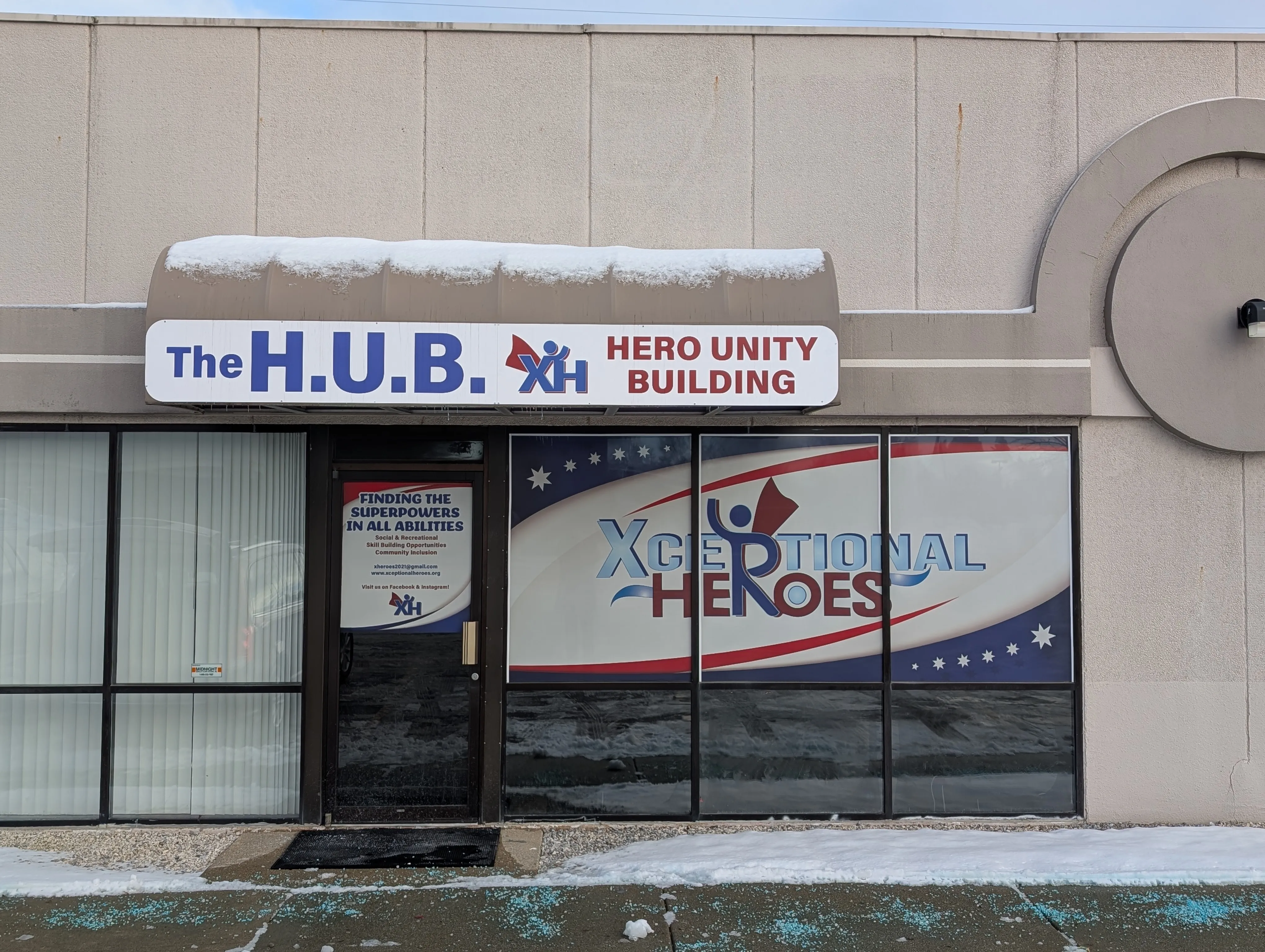 The HUB storefront on Miller Road in Mid-Michigan — sign reading 'The H.U.B. Hero Unity Building' and the Xceptional Heroes window graphic.